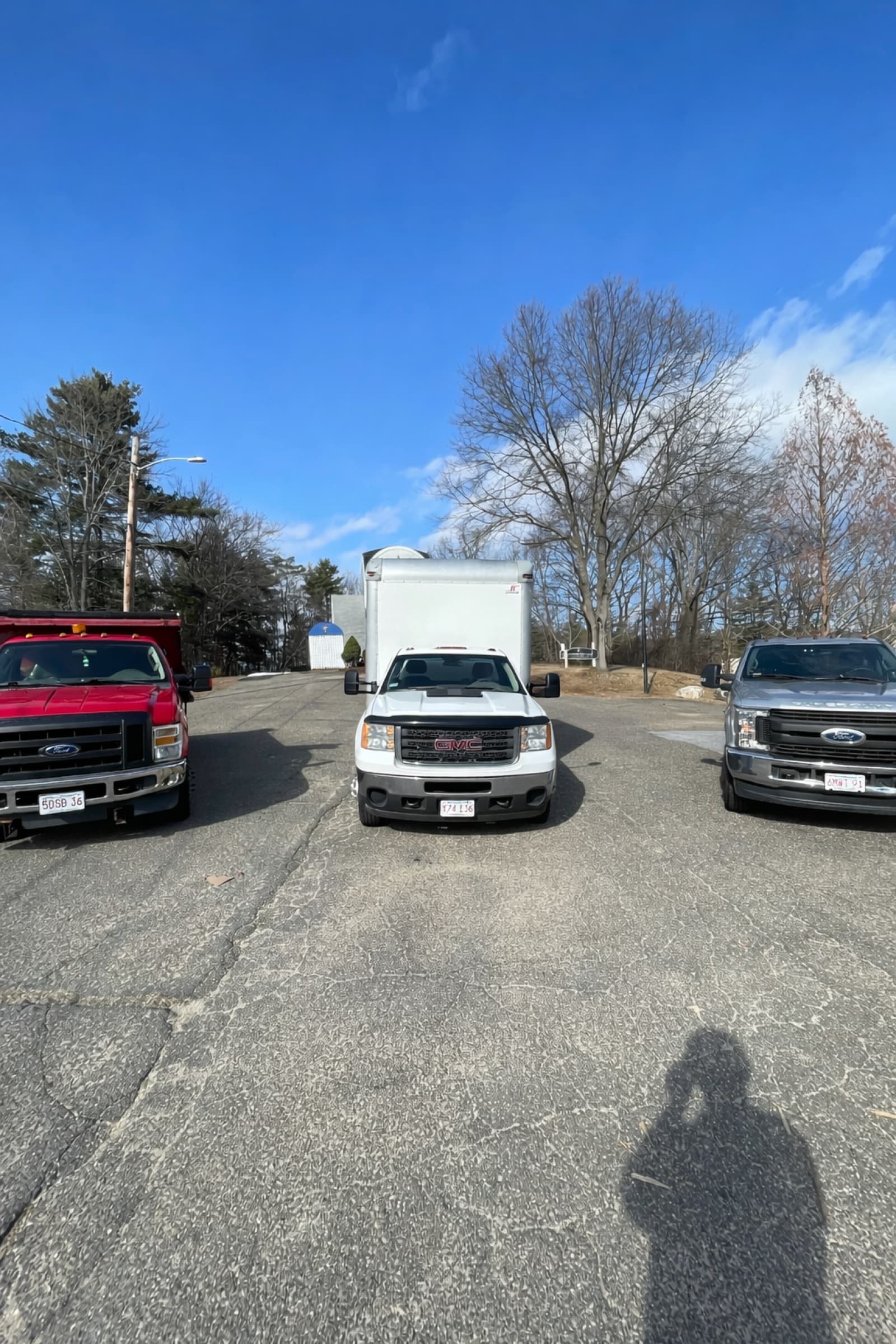 Three Downie and McGlone junk removal trucks parked and ready for local hauling work